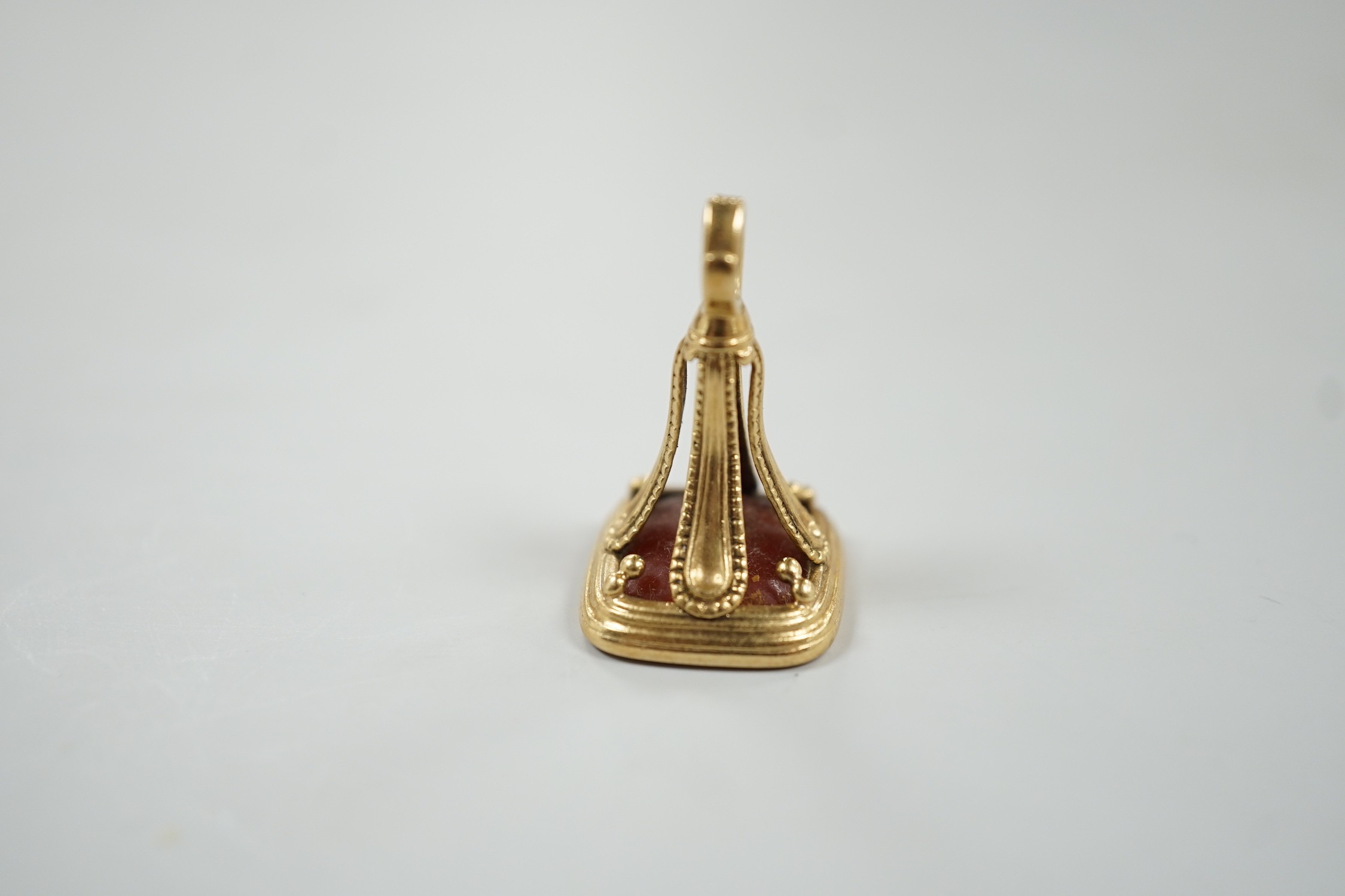 An early 19th century yellow metal overlaid and carnelian set fob seal, the matrix carved with armorial, 29mm.